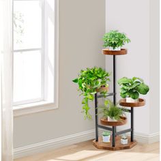 three tiered plant stand with potted plants