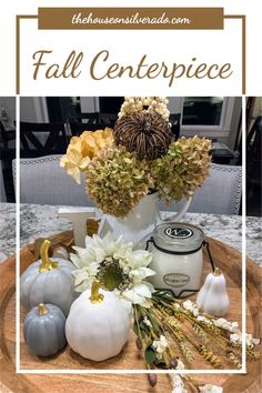 fall centerpiece with white pumpkins and flowers