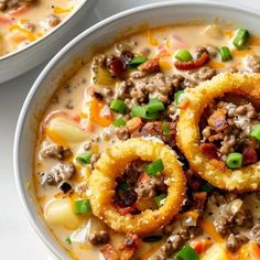 two bowls filled with soup and onion rings