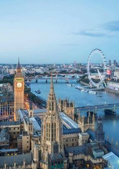 an aerial view of the city of london with big ben in the foreground and the river thames behind it