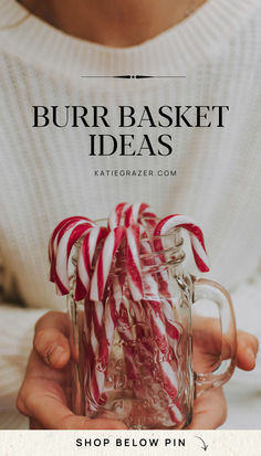 a person holding a mug with candy canes in it and the text, shop below