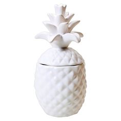 a white ceramic pineapple shaped container on a white background