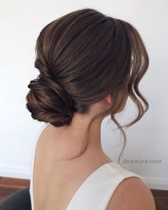 a woman with her hair in a low bun