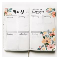 an open planner with flowers on it and the words may written in cursive writing