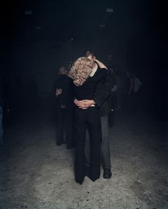 a man and woman embracing in the dark