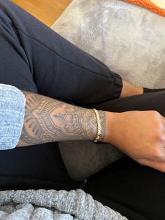 a person with tattoos sitting on a couch