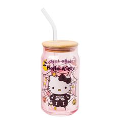 a hello kitty glass jar with a straw in the lid and a spider web on it