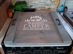 a camper sign on top of an oven in a kitchen