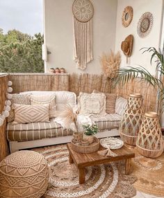 a living room filled with lots of furniture and decor on top of a wooden floor