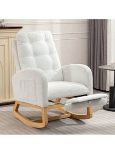 a white rocking chair and ottoman in a living room