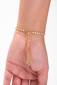 This Finley Gold Plated CZ Tennis Bolo Slider Bracelet brings a touch of elegance to any outfit. The sparkling CZ stones are carefully placed to capture the light and add a touch of luxury. The adjustable bolo slider makes it easy to wear and comfortable. Elevate your style with this stunning bracelet. SizeLENGTH: 16" WIDTH: 0.25" QualityMade with premium materials for endurance. ImportedBCZ12718 Slider Bracelet, Pearl Shop, Holiday Essentials, Pearl Set, Tennis Bracelet, Cz Stone, Pearl Ring, Adjustable Bracelet, Diamond Wedding Bands