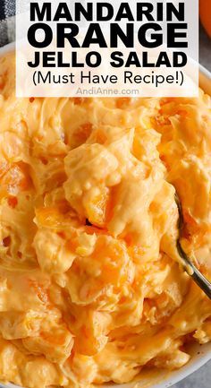 an orange jello salad in a white bowl with a spoon and text overlay that reads, mandarin orange jello salad must have recipe