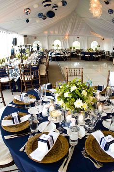 the tables are set for an event with white and blue linens