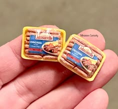 two small pieces of food sitting on top of each other in someone's hand