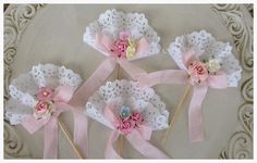 four pink and white flowers with lace on them