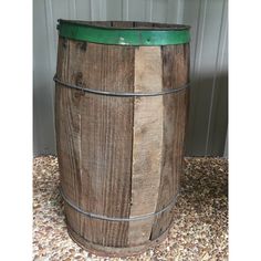 a wooden barrel sitting on top of gravel