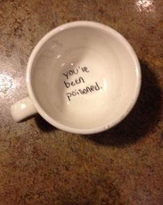 a coffee cup with the words you're awkward, that awkward moment when you find this at the bottom of your cup