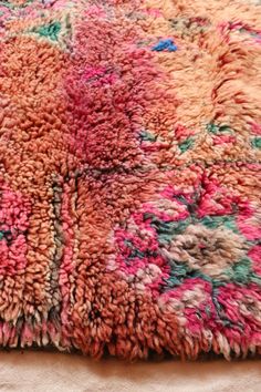 a multicolored area rug on top of a bed