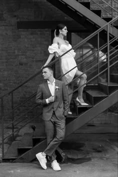 black and white photograph of man and woman on stairs