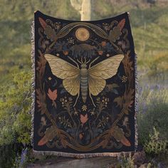 a black and yellow tapestry with a bee on it's back in the middle of a field