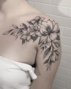 a woman's shoulder with flowers on it