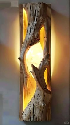 a wooden sculpture is shown with light coming from it's center hole in the wood