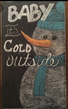 a chalkboard drawing of a snowman with the words baby it's cold outside