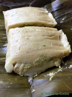 two pieces of food sitting on top of a banana leaf