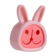 a pink bunny head with two holes in the middle