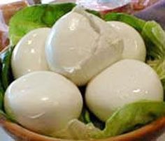 a bowl filled with hard boiled eggs on top of lettuce