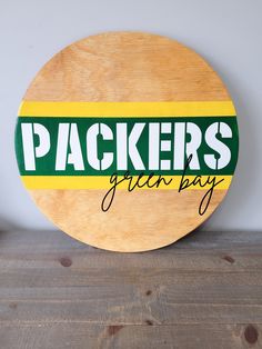 a wooden sign that says packers green bay