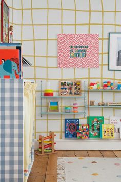 there are many books on the shelves in this child's playroom with toys