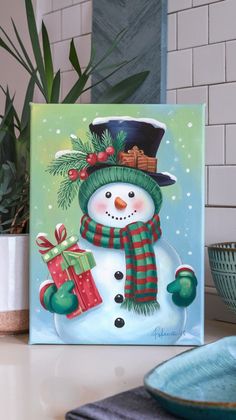 a painting of a snowman wearing a green hat and scarf with presents on it