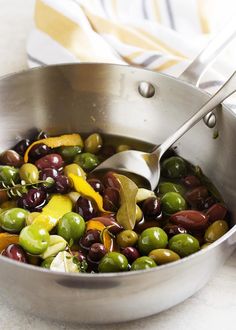 olives and peppers are being cooked in a pot