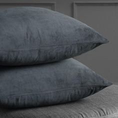 two pillows are stacked on top of each other