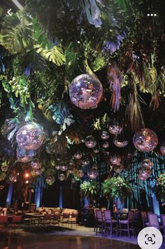 a large room filled with lots of lights and hanging disco balls above the dance floor