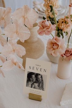 a table topped with vases filled with pink flowers