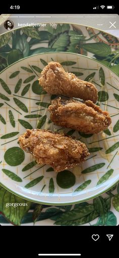 fried chicken on a plate with green leaves