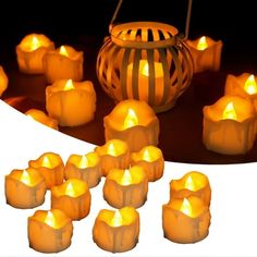 many lit candles sitting next to a lantern