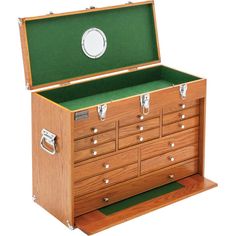 an open wooden chest with drawers and green lining on the top shelf, showing its contents