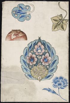 an old book with blue and white designs on it's cover, including leaves and flowers