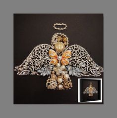 an angel brooch with pearls and jewels on it's wings is shown in front of a black background