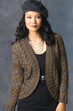 a woman in a black dress and jacket posing for a photo with her hand on her hip