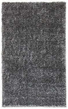 an area rug with grey shag on it