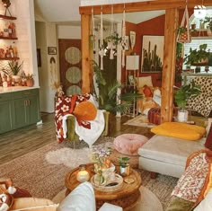 a living room filled with lots of furniture and plants