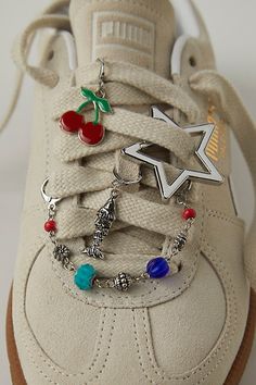 Add a little something special to your shoe game with this set of charms featuring dangly details, drapey chains, and defined pins for the perfect finishing touch. | Shoe Charm & Pin Pack by Free People in Red Shoe Clips Sneakers, Bubble Shoes Charms, Unique Accessories Fashion, Charms On Shoes, Shoe Charms Diy, Shoe Lace Charms, Sneaker Charms, Interesting Accessories, Shoes Charm