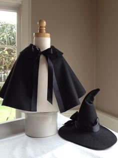 a hat and cape sitting on top of a table