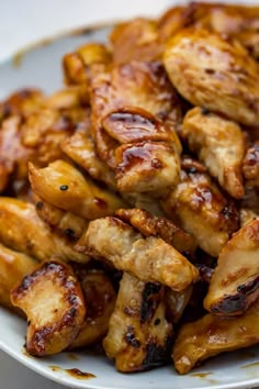 chicken wings on a white plate with brown sauce