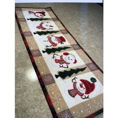 the table runner is decorated with red and black plaid fabric, featuring santa's