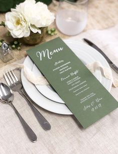 a table setting with silverware and menu cards